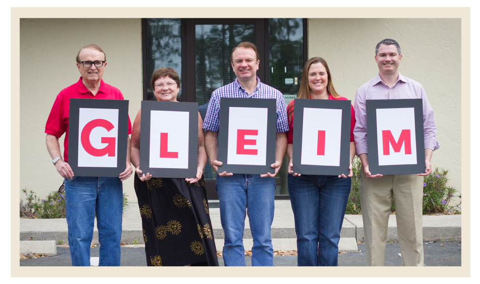 From left to right: Dr. Gleim, Mrs. Gleim, Larry, Lorie, and Garrett holding up letters that spell out Gleim.